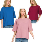 Three women wear Zenana Double Knit Short Sleeve Tops in blue, burgundy, and light pink, each paired with light blue jeans for an easy everyday look.