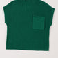 The Shewin Patch Pocket Ribbed Knit Short Sleeve Sweater, crafted from green knit fabric, features a small front pocket and short sleeves, perfect for transitional weather.