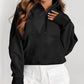 A woman with long wavy hair wears a Shewin gray zip-up stand collar ribbed thumbhole sleeve sweatshirt made of high-quality material and white shorts.