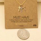 The Anarchy Street Triple Cross Pendant Necklace features a gold-dipped triple cross design on a chain, shown with a U.S. quarter for size reference.