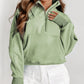 A woman with long wavy hair wears a Shewin gray zip-up stand collar ribbed thumbhole sleeve sweatshirt made of high-quality material and white shorts.