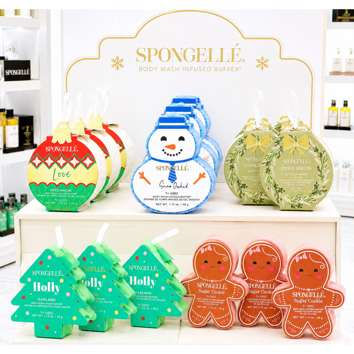 A store display of Spongelle Holiday Bath Soap Sponges shaped like holiday ornaments, snowmen, wreaths, Christmas trees, and gingerbread men.