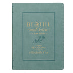 Teal faux leather Devotional Be Still and Know Faux Leather Teal book with gold embossed text that reads, “Be Still and Know I am God, a daily devotional by Michelle Cox.”