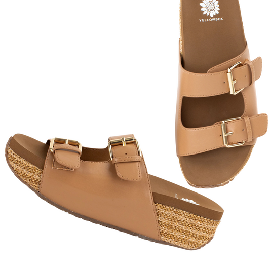 Bahia Adjustable Platform Slide Sandal in Almond by Yellow Box with two adjustable buckle straps and woven jute-wrapped wedge heels, perfect for any summer occasion. The insoles are branded "YELLOW BOX - CIT" with a flower logo.