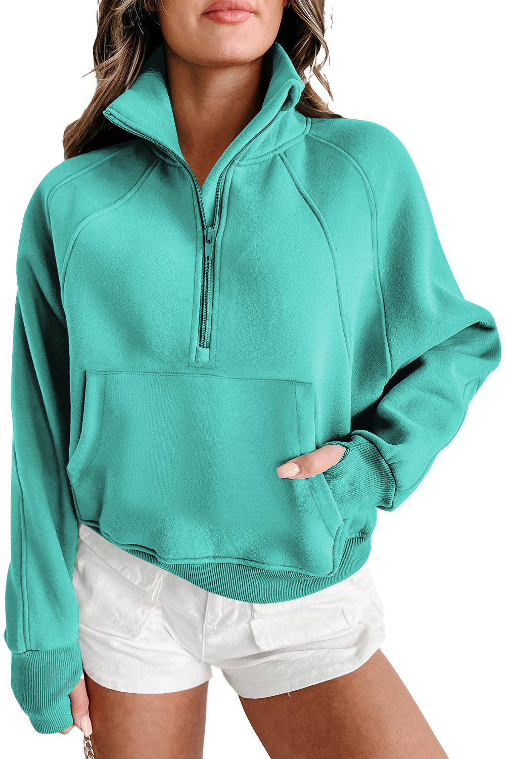 A person wearing a Shewin gray zip-up stand collar ribbed thumbhole sleeve sweatshirt and white shorts is standing against a plain background.