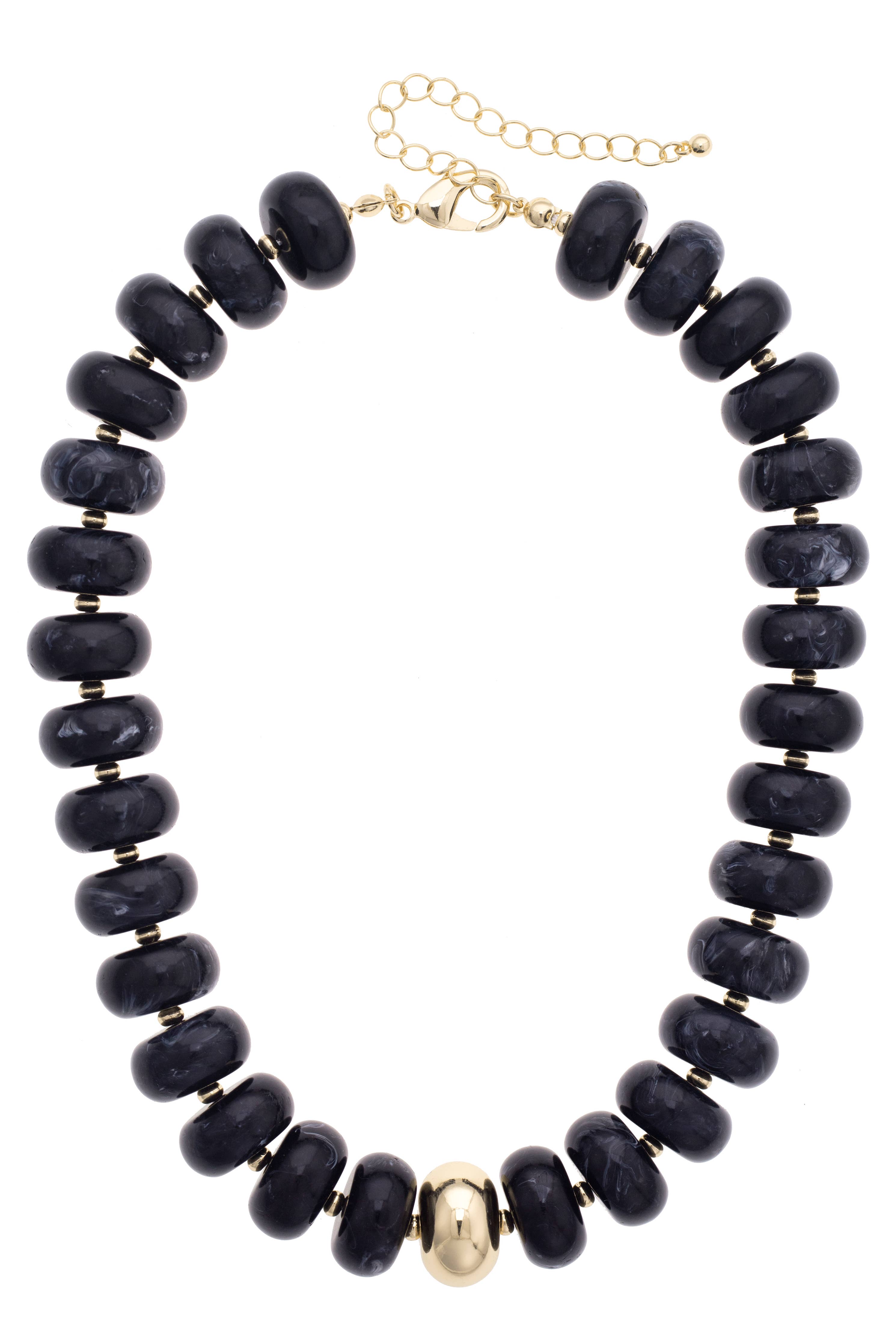 Add bold elegance to any outfit with the San Sebastián Beaded Resin Necklace by Canvas Style, featuring large round black resin beads, a single central gold bead, small gold spacers, and a gold adjustable clasp.