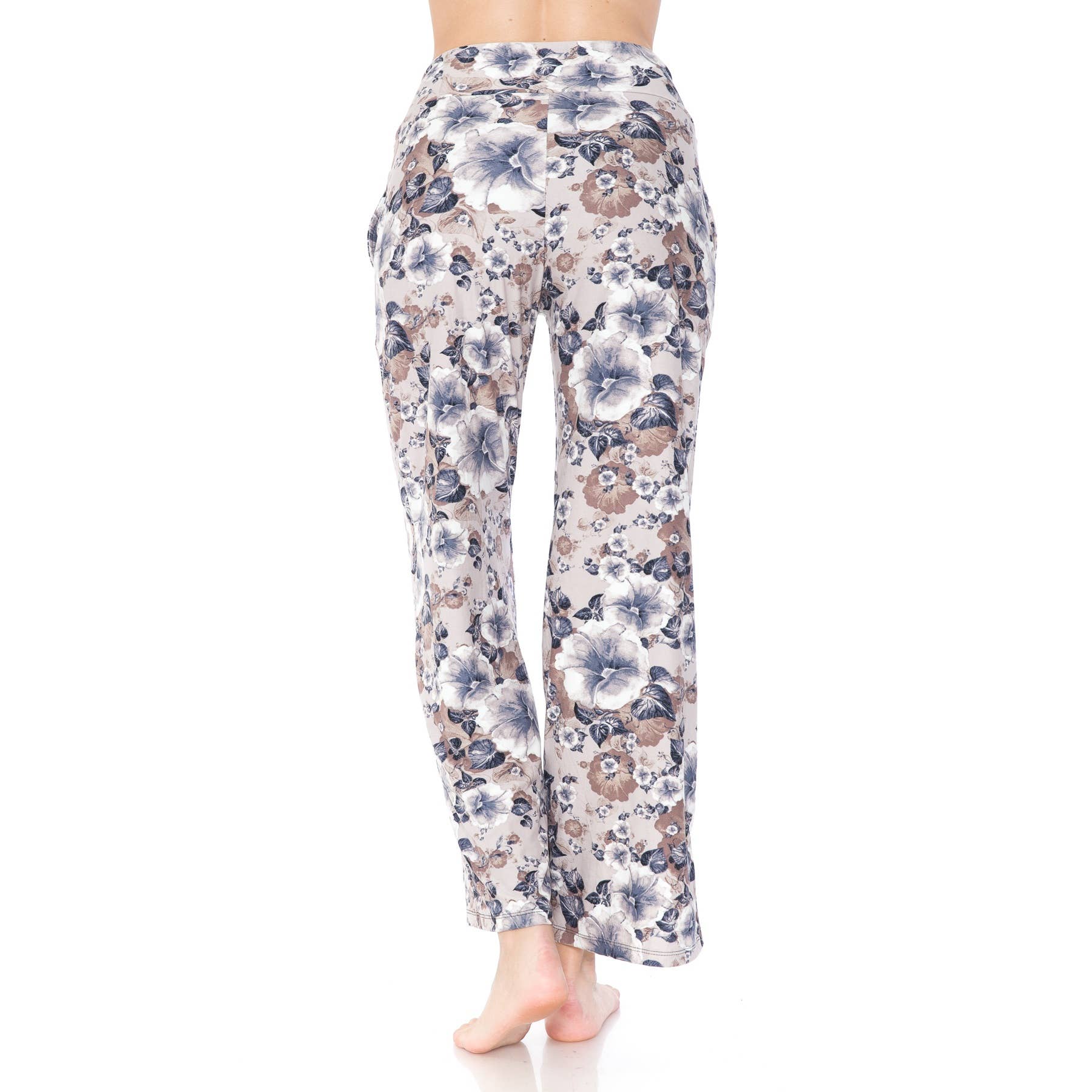 A person stands barefoot, facing away, wearing Leggings Depot Buttery Soft Print Pajama Pants with a relaxed fit, elastic waistband, and functional pockets in a light-colored floral print against a white background.