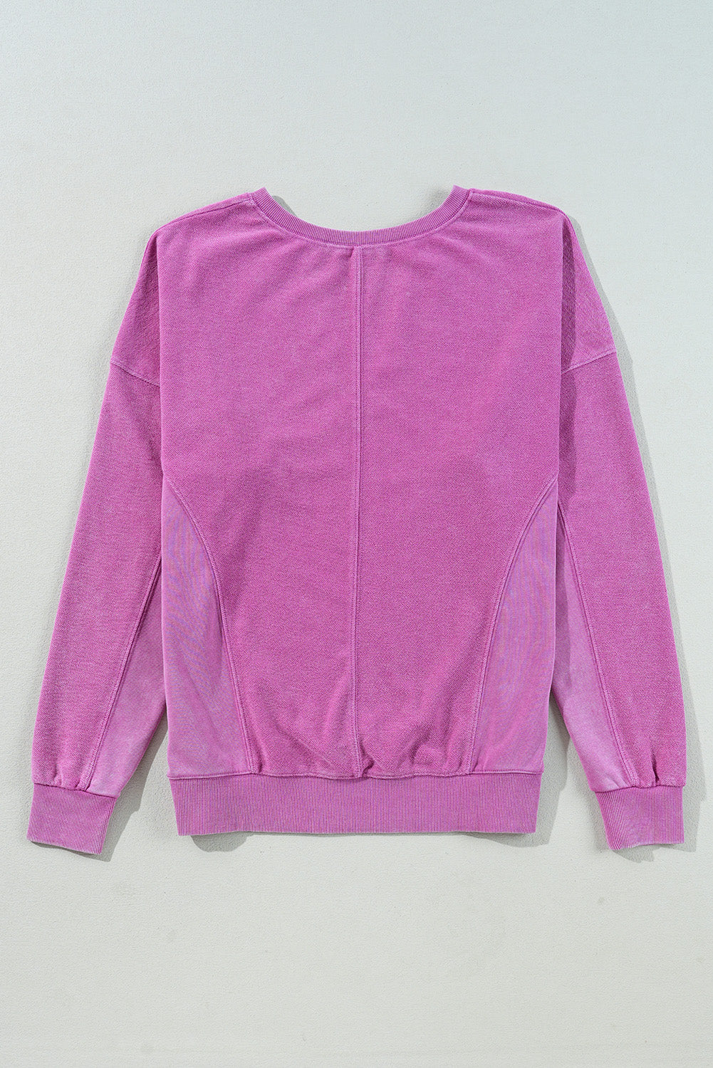 A Notched Neck Exposed Seam Drop Shoulder Sweatshirt by Shewin, in pink and made of high-quality fabric, is comfortable and displayed flat on a light background.