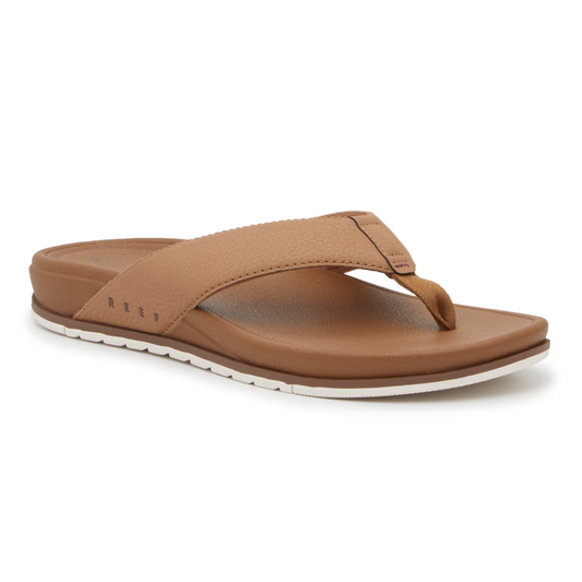 The REEF Cushion Bonzer Women's Flip-flops in Tan with a cushioned footbed are on a white background.