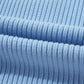 Close-up of a soft-textured light blue knit fabric, similar to Shewin's Patch Pocket Ribbed Knit Short Sleeve Sweater, with horizontal folds.