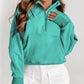 A person is wearing a Shewin Gray Zip-Up Stand Collar Ribbed Thumbhole Sleeve Sweatshirt, paired with white shorts.