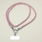 A Sensibling Corp. Rhinestone Phone Lanyard Necklace in pink, featuring a beaded design with a silver clasp and a blank rectangular name tag attached, is displayed on a plain light surface; this versatile accessory also functions as a stylish cell phone holder or rhinestone strap.