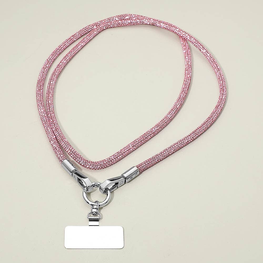 A Sensibling Corp. Rhinestone Phone Lanyard Necklace in pink, featuring a beaded design with a silver clasp and a blank rectangular name tag attached, is displayed on a plain light surface; this versatile accessory also functions as a stylish cell phone holder or rhinestone strap.