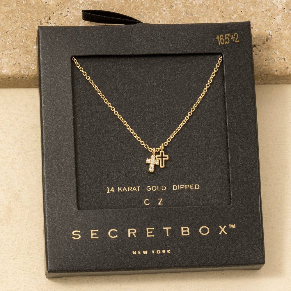The Anarchy Street Secret Box Gold Dipped Cz Cross Pendant Necklace features two small cubic zirconia cross pendants, displayed in black packaging labeled "14 Karat Gold Dipped CZ.