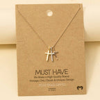 The Anarchy Street Triple Cross Pendant Necklace, gold-dipped in rose gold, comes displayed on a branded brown card labeled "Must Have" and "Handmade in Korea.