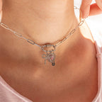 A close-up of a person wearing the WJW 18K Gold PVD Paperclip Carabiner Necklace, featuring a paperclip chain and a heart-shaped pendant adorned with rhinestones.