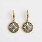 Ellemadera Enamel Drip Art Dangle Earrings in gold, featuring round floral-patterned pendants with blue, white, and pink enamel accents in an elegant Palace Style Jewelry design, displayed on a white background.