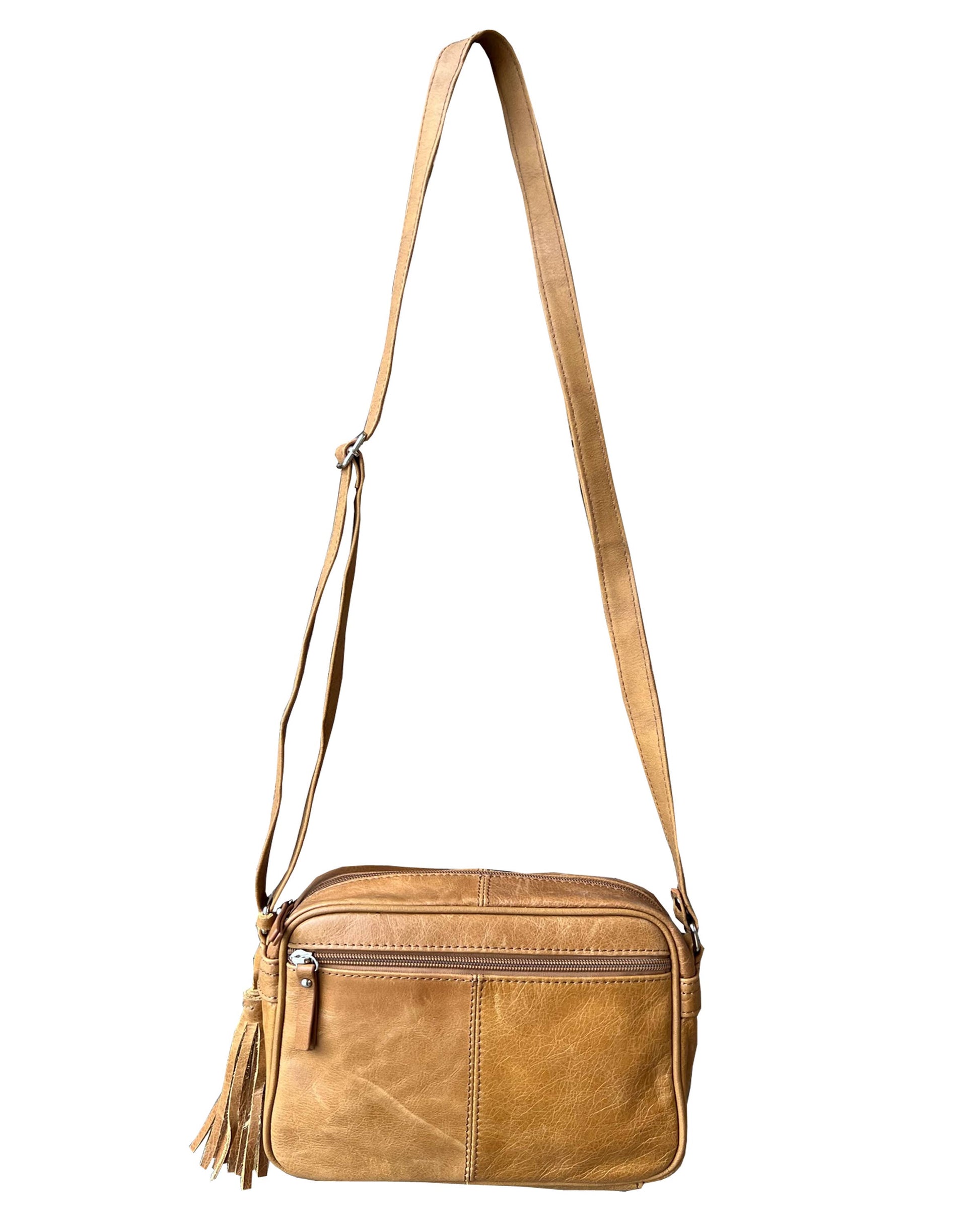 The Roma Leathers, Inc. Cowhide Leather Crossbody features tan cowhide leather, an adjustable shoulder strap, a front zipper pocket, and a decorative side tassel, shown against a white background.
