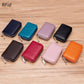 Eight ACCITY CARD WALLET Anti-Theft Wallets, featuring RFID protection, are displayed on a wooden surface in navy, turquoise, lavender, black, brown, red, pink, and orange.