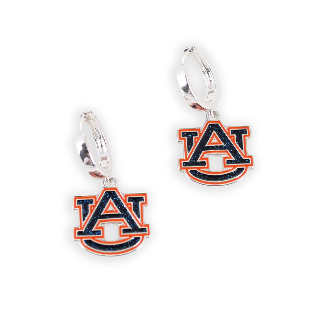 Showcase your team spirit with the Auburn Glitter Enamel Logo Huggie Hoop Earrings by Seasons Jewelry—featuring sparkling navy blue and orange "AU" logo charms on sleek silver huggie hoops, perfect for devoted Auburn fans on game day.