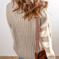 A person with wavy hair wears a Shewin Khaki Cable Knit Colorblock Crew Neck Drop Shoulder Sweater, pairs it with jeans, and carries a brown crossbody bag.