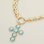 Introducing the Pearl Cross Charm Pendant Chunky Chain Statement Necklace from Sensibling Corp.—a bold gold chain necklace featuring a textured cross pendant accented with six round, light blue stones.