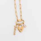 WJW 18K Gold PVD Paperclip Carabiner Necklace featuring a heart-shaped lock charm, a script "fierce" charm, and a small teardrop gemstone charm on a white background. This stylish necklace is perfect as a customizable accessory to showcase your unique style.