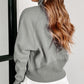 A woman with long wavy hair wears a Shewin gray zip-up stand collar ribbed thumbhole sleeve sweatshirt made of high-quality material and white shorts.