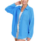 A woman wearing a blue Gauze Oversized Raw Edge Button Up Shirt by FASHION GO with a front button-up design.