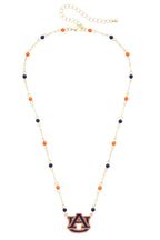 Show your team spirit with the Auburn Tigers Logo Layering Necklace by Canvas Style. This adjustable gold chain necklace features alternating orange and navy beads and a central Auburn University "AU" logo pendant—making it the perfect accessory for game days or everyday style. The customizable length ensures a comfortable fit for any look.