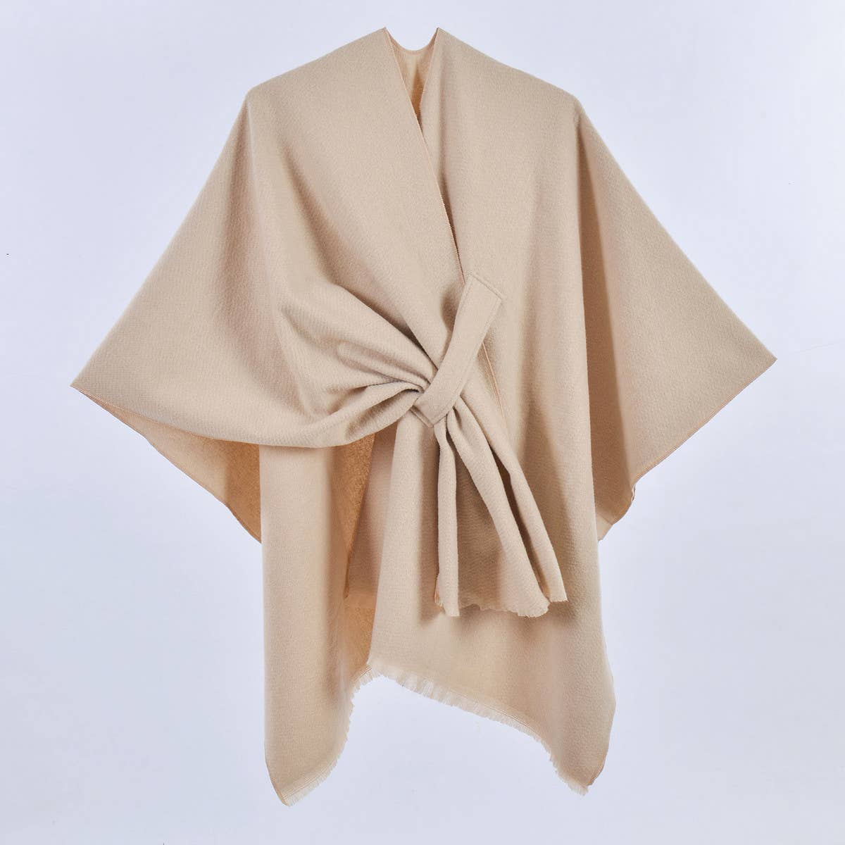 The ACCITY SIMPLE SOLID COLOR OBLIQUE STRAP CAPE SHAWL in beige wool features a tied front, ideal for layering, shown against a plain white background.