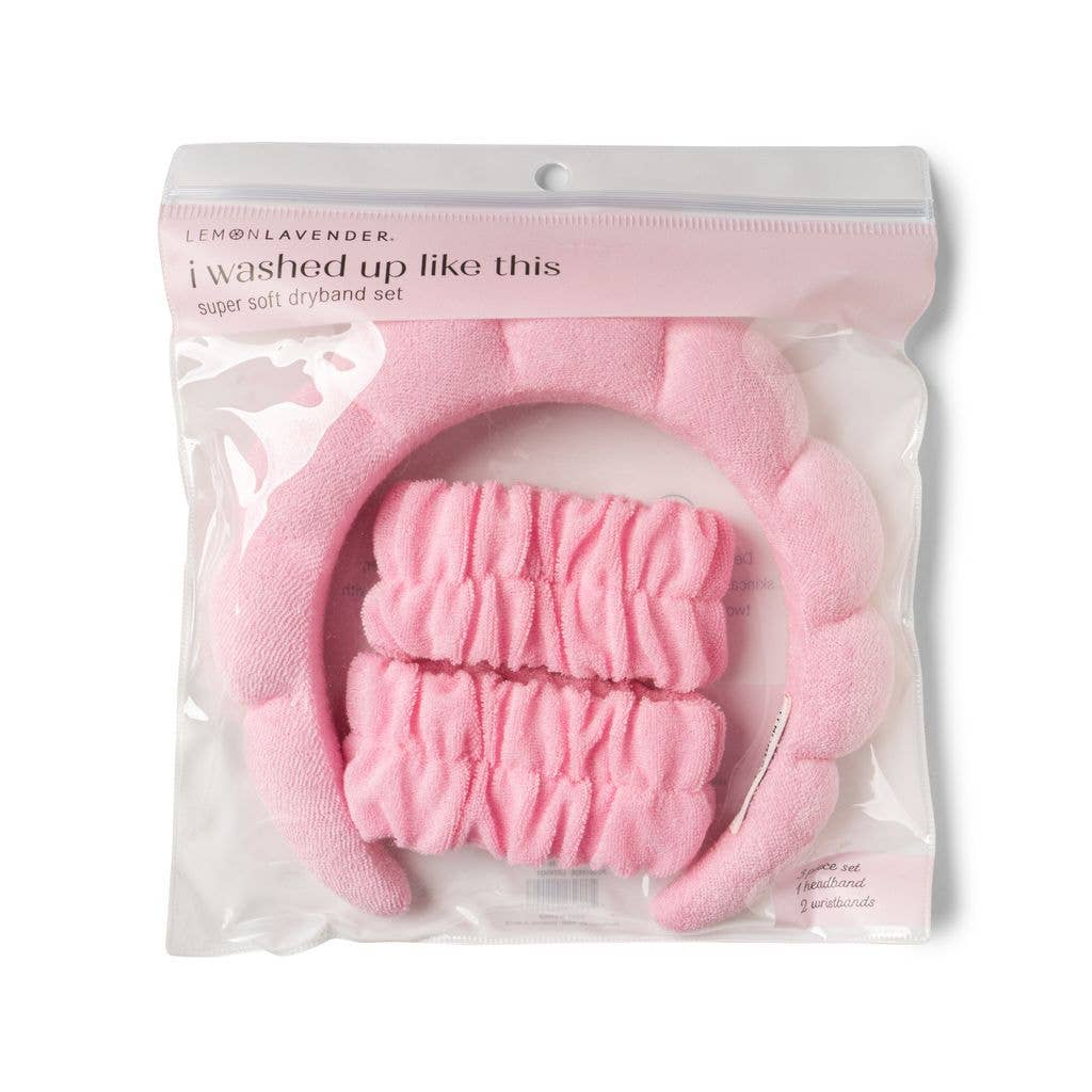 An I Washed Up Like This Super Soft Dryband Set containing a pink skincare headband and two matching absorbent terrycloth wristbands for washing your face, packaged in a clear plastic retail bag.