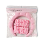 An I Washed Up Like This Super Soft Dryband Set containing a pink skincare headband and two matching absorbent terrycloth wristbands for washing your face, packaged in a clear plastic retail bag.