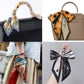 Four images show the ACCITY Floral Letter Scarf Hair Tie Ribbon styled on a black bag handle, a tan handbag, around a wrist, and as a black-and-white bow on a keychain.