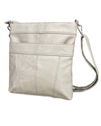 The Roma Leathers, Inc. cowhide leather crossbody bag features a long adjustable strap, vertical stitching, and secure zippered top pockets for storage.