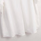 A close-up of the White Relaxed Short Sleeve Blouse by Rosa Clothing, stylishly displayed against a light background.