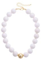 The Marjorie Game Day Beaded Necklace by Canvas Style features oversized white round beads accented with a single gold bead at the center, finished with a gold clasp and adjustable chain for a bold, modern chunky look.