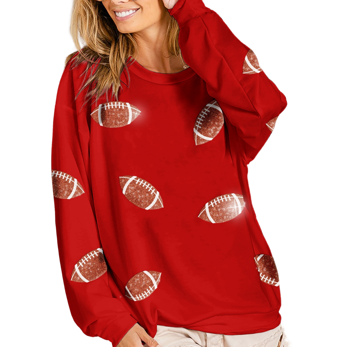 A woman smiles while wearing a FASHION GO Sequin Football Sweatshirt in Red adorned with sequined football graphics.