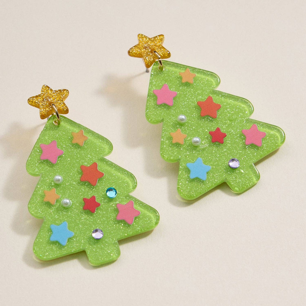 The Glittery Christmas Tree Drop Earrings by Lilla Haven are festive holiday statement pieces, expertly crafted from glitter acrylic and embellished with colorful star and pearl decorations, featuring gold glitter star tops. Displayed on a light background, these Holiday Acrylic Earrings capture the joyful spirit of the season.