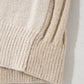 Close-up of the Shewin Khaki Cable Knit Colorblock Crew Neck Drop Shoulder Sweater, showcasing its rib-knit details and relaxed silhouette on a light surface.