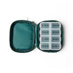 Open zippered Wellness Keeper Zippered Pill & Vitamin Case containing an 8-compartment 7-day pill organizer labeled with the days of the week.