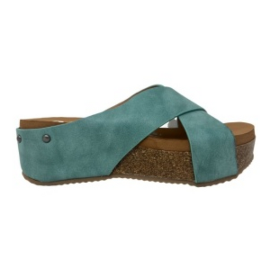 A beautiful Hero Platform Wedge Slide Sandal in Turquoise by Very G with crisscross straps, a brown footbed for comfort, and a cork platform sole.