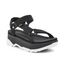 The Jadito Universal Sandal in Black by Deckers, features a thick white sole, adjustable straps, a subtle platform, and is made from recycled plastic.