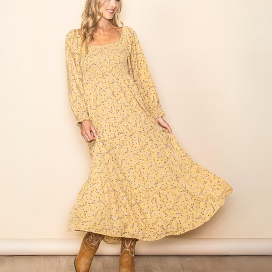 A woman wearing a FASHION GO Romantic Floral Square Neck Maxi Dress in Dandelion.