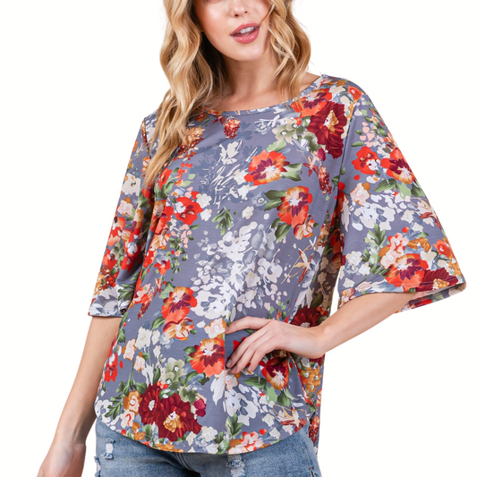 Woman wearing a comfortable Everyday Floral Top by BOM BOM with three-quarter sleeves from FASHION GO.