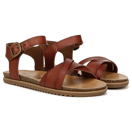 A pair of Women's Monti Sandals in Henna by Blowfish with faux leather upper, buckles, and a flat sole from CALERES INC.