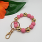 A Gold and Color Bead KeyChain with a gold key ring by Ganz Inc.