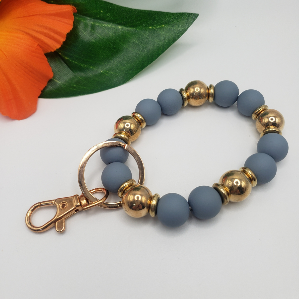 A Gold and Color Bead KeyChain with a Ganz Inc clasp.