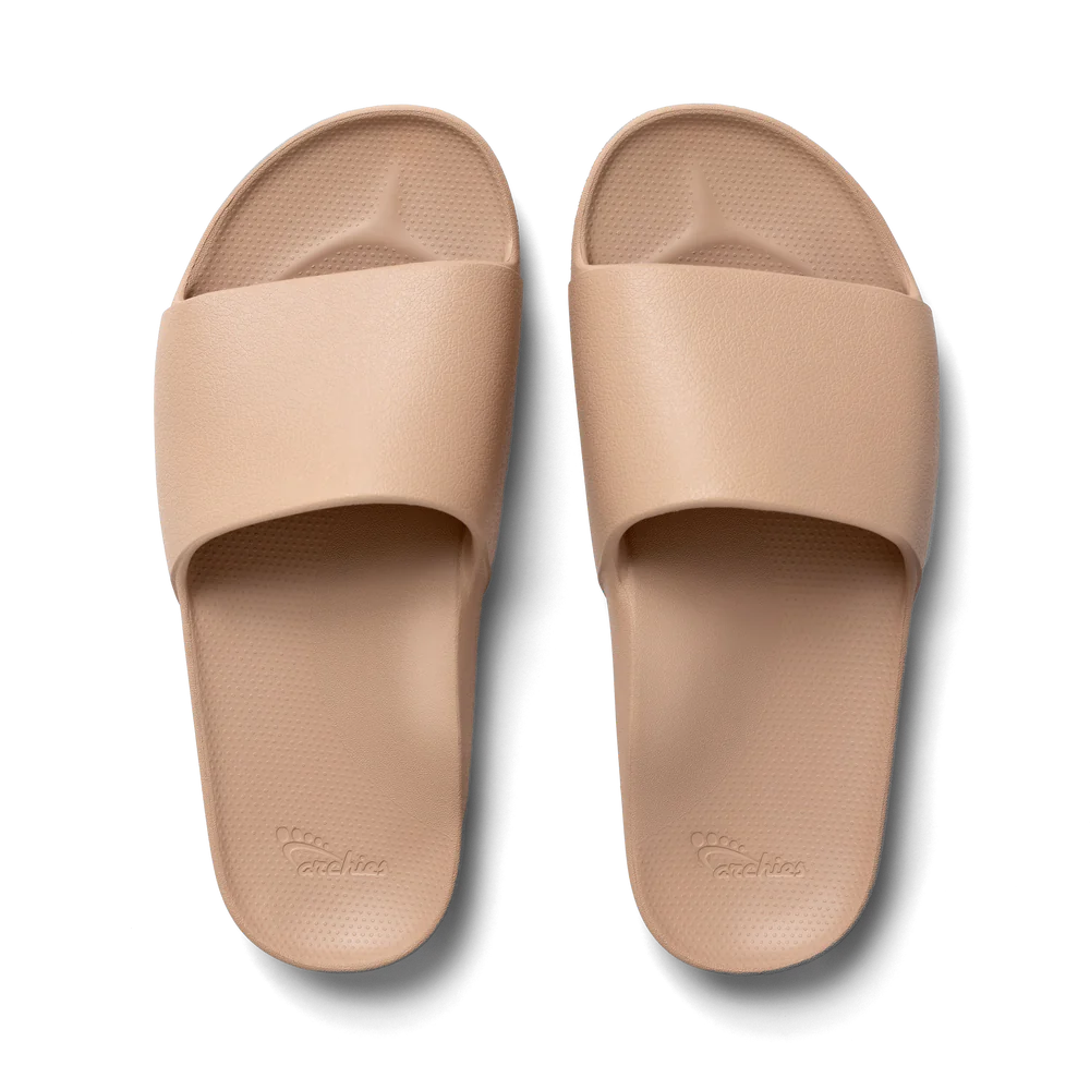 A top-down view of the ARCHIES SLIDES TAN from ARCHIES FOOTWEAR LLC, featuring textured footbeds and wide straps.