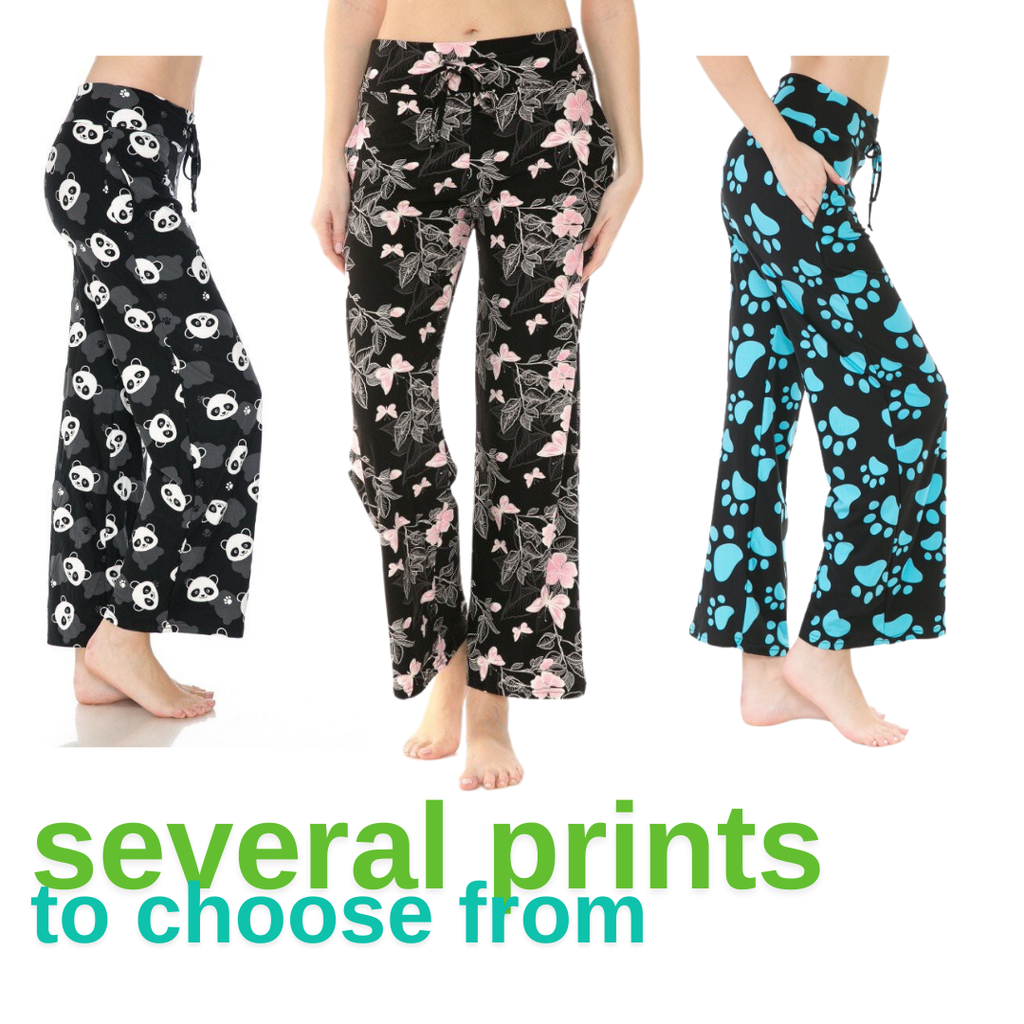 Three women wearing the Buttery Soft Pajama Pants with Drawstring by FASHION GO are seen sporting a variety of patterns—panda, pink floral, and blue paw prints. The pants feature an elastic waistband and come with the phrase "several prints to choose from" displayed in green.